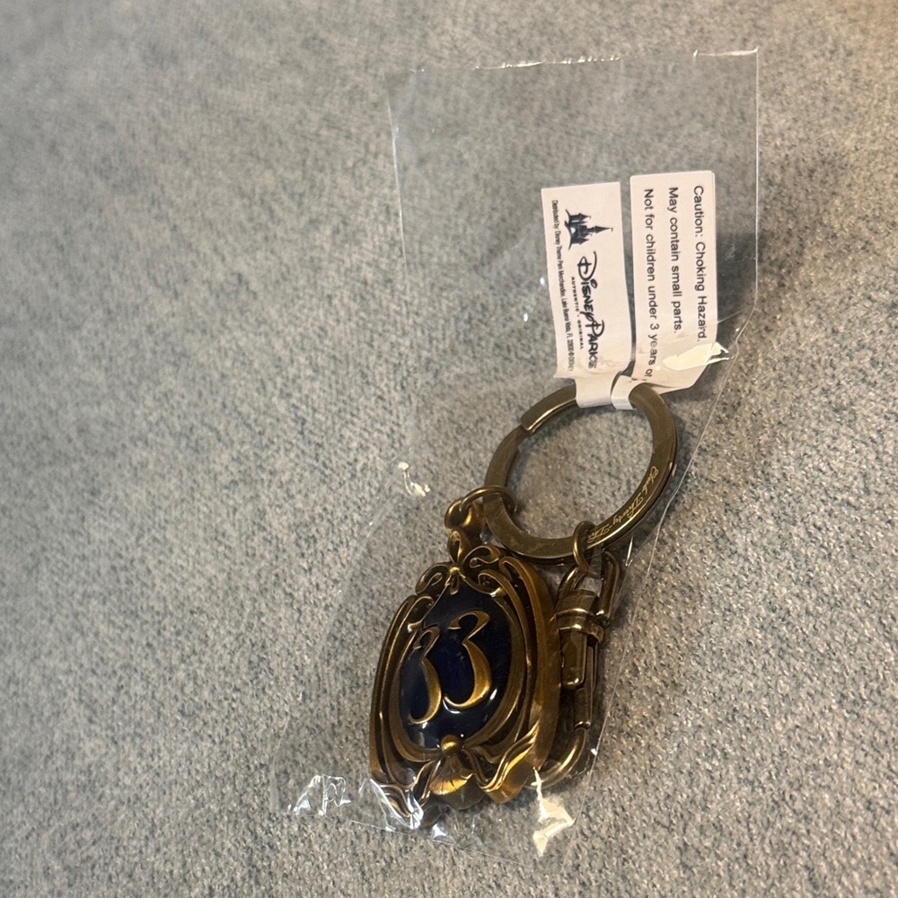 Disney Club 33 blue and gold keychain NWT